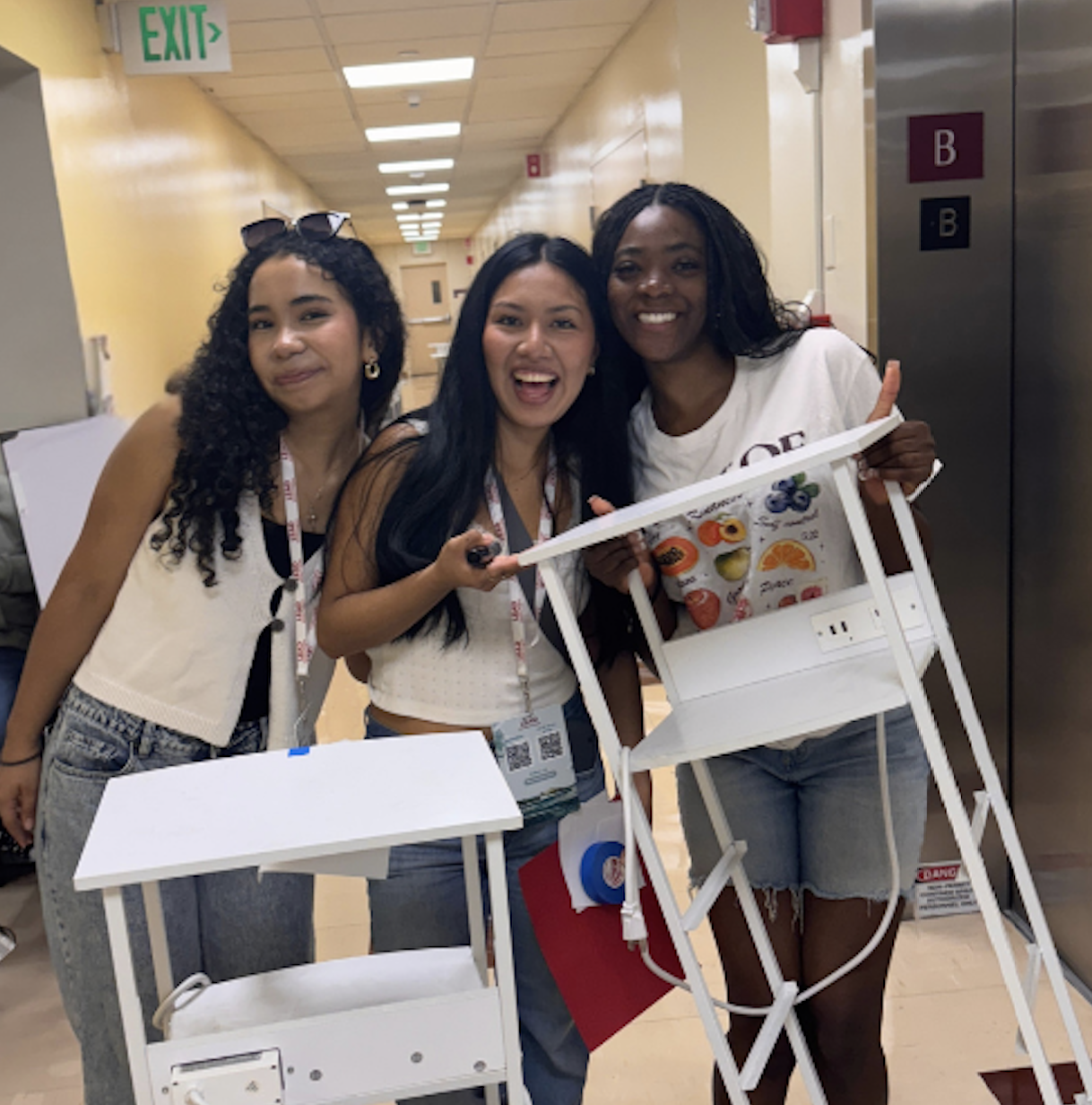 3 students show off the organizers they found at Bronco Surplus